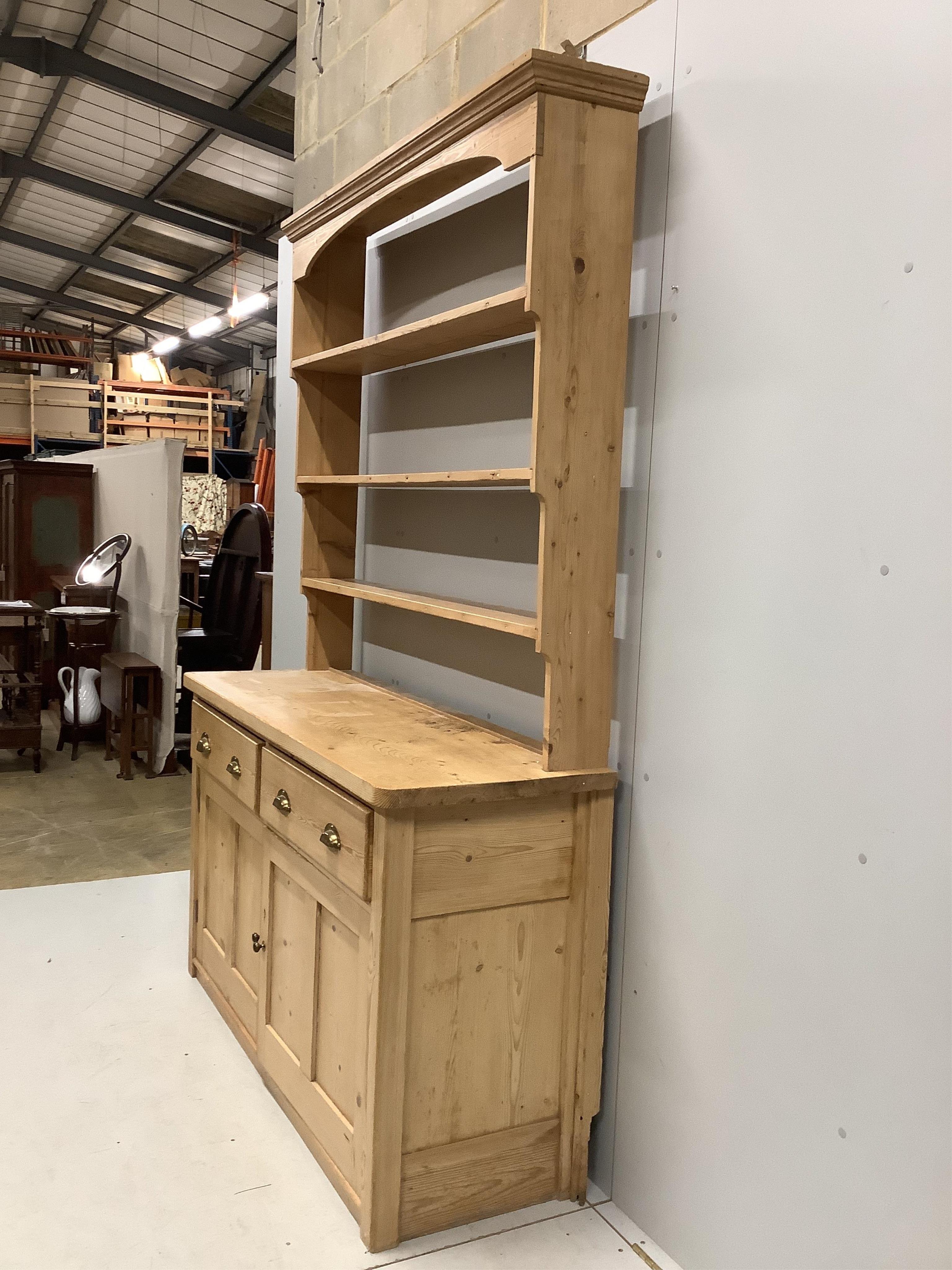 A Victorian pine dresser with open rack, width 152cm, depth 51cm, height 221cm. Condition - fair to good.